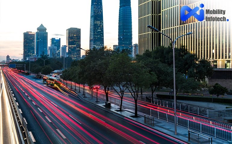 City traffic with light trails and skyscrapers at dusk