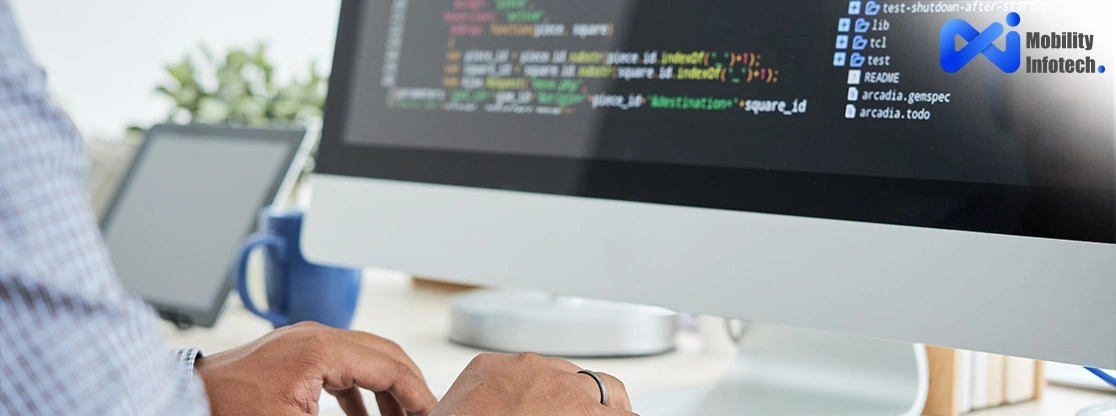 Programmer coding web application at Mobility Infotech